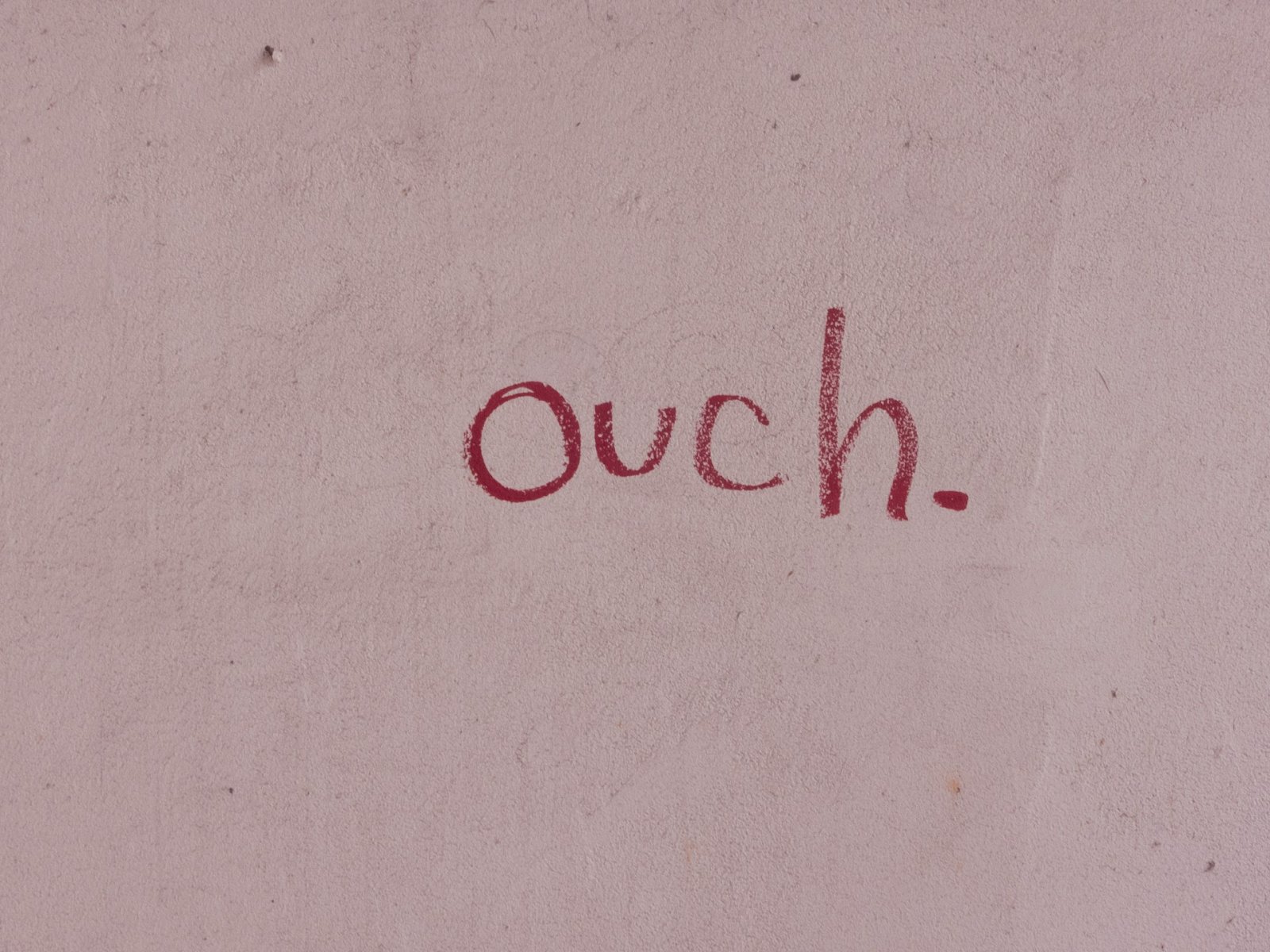 Ouch written on the wall in pink - https://unsplash.com/photos/ouch-sign-SG9Ycz2uqGs