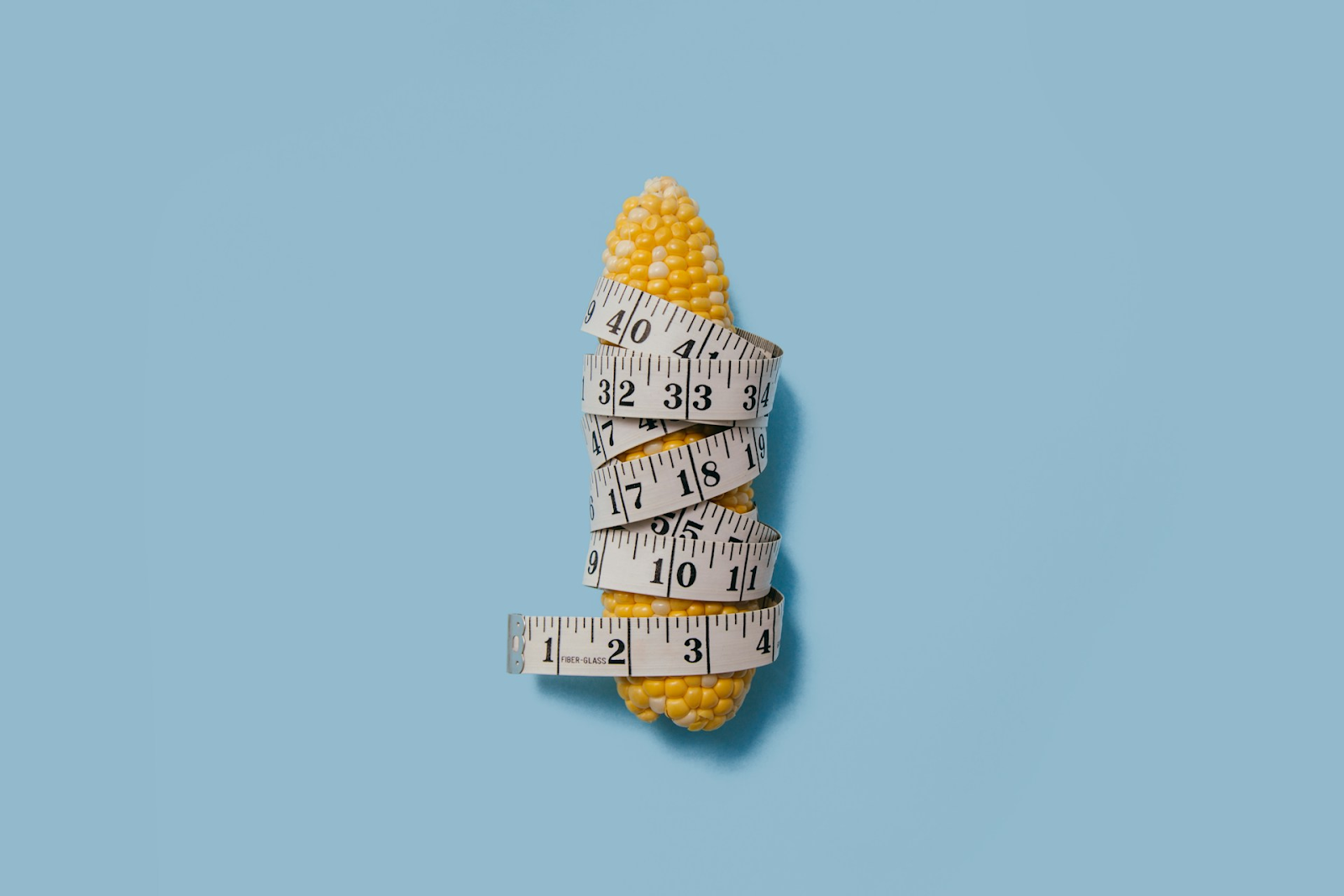 A piece of corn wrapped in a tape measure, using a penis pump makes it bigger by stimulating blood vessels - https://unsplash.com/photos/yellow-corn-iuAMkSsQsIY