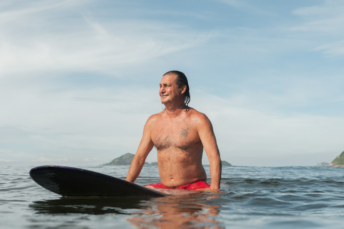 An older man still in his sexual peak on a surfboard
