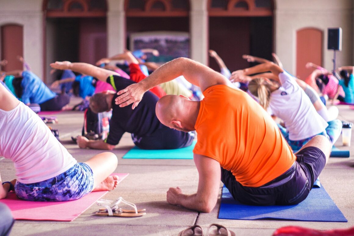 A man working his body in a yoga class