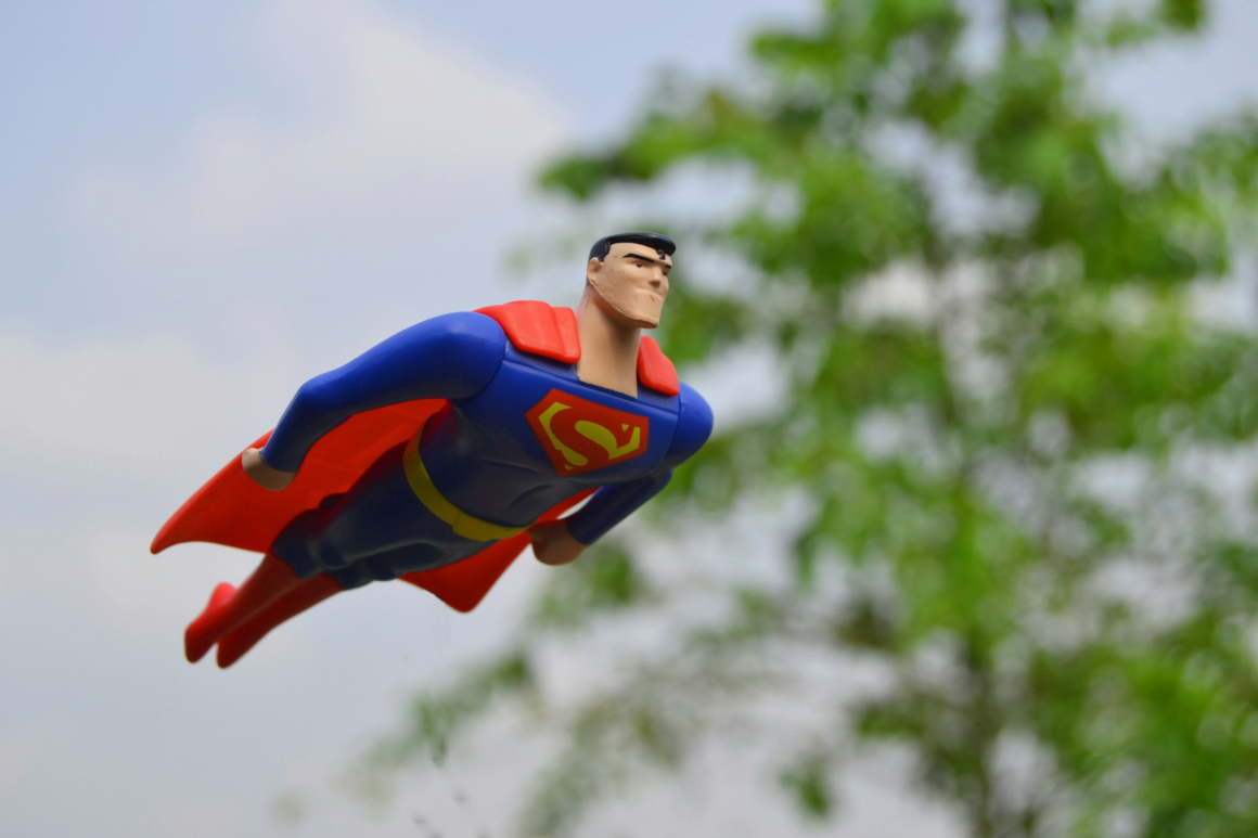 A toy of Superman flying through the air