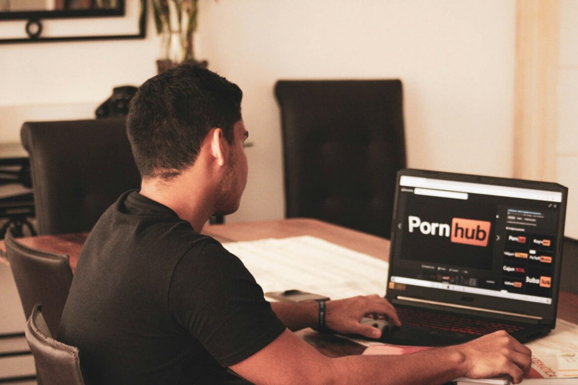 A man looks sad while watching the PornHub loading screen, trying to feel pleasure