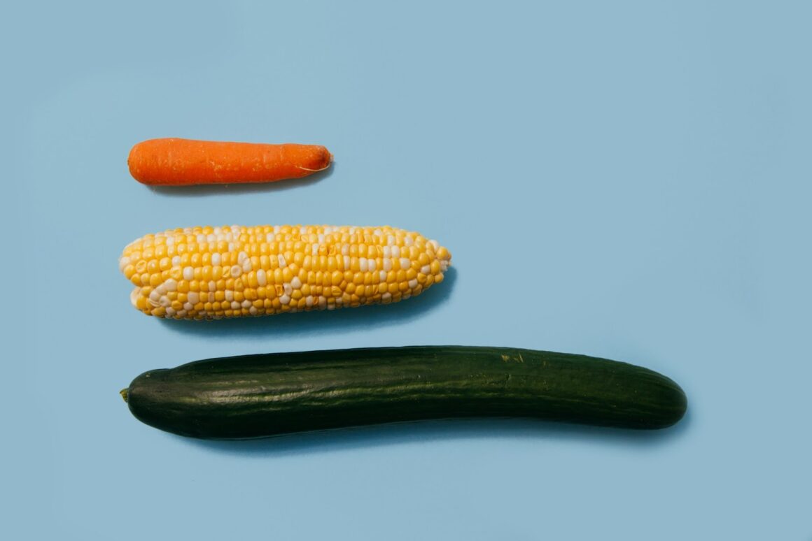 A carrot, sweetcorn cob, and cucumber all lined up together to represent varying penis sizes.