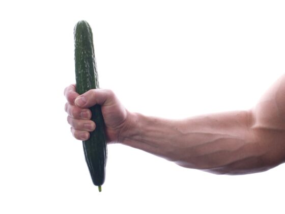 man holding a bitter gourd