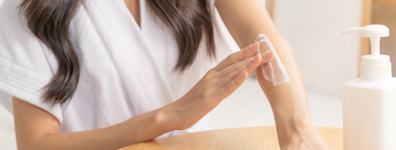 woman applying moisturizer on her arm