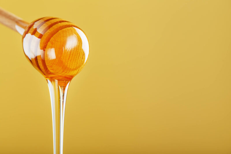 honey dripping from a spoon