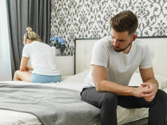 Sad couple after conflict in bedroom