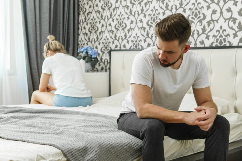 Sad couple after conflict in bedroom