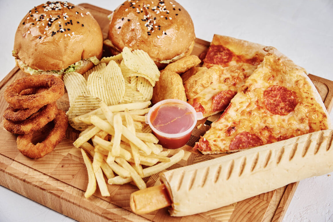 a cutting board full of junk food