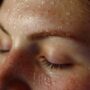 close up of a woman's face with sweat