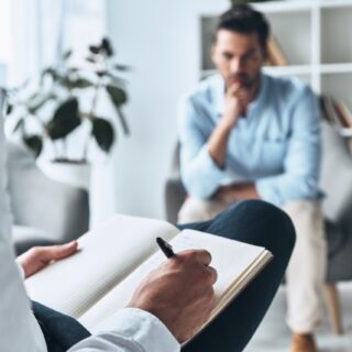 man consulting a therapist