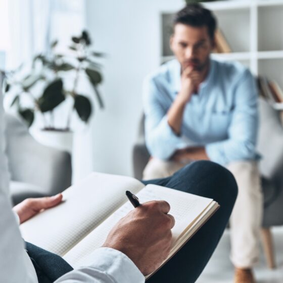 man consulting a therapist