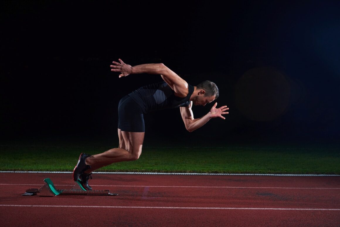 male sprinter leaving starting blocks