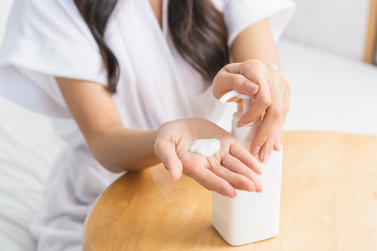 woman squeezing out lotion from a bottle