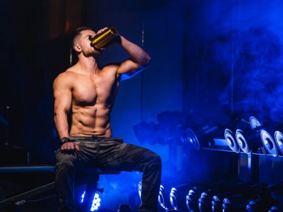 man drinking pre-workout in a gym