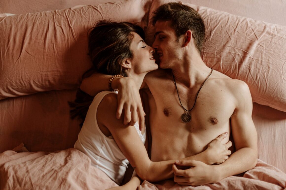 young couple cuddling in bed