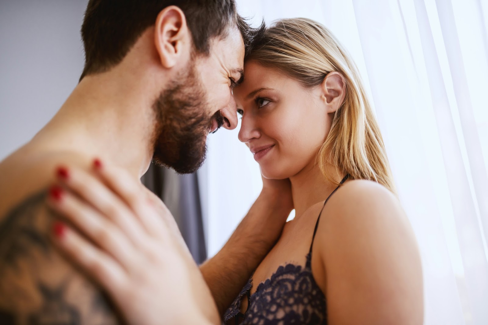 A man and his lady getting intimate in the bedroom
