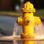 yellow fire hydrant about to burst