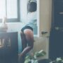beautiful young woman in panties looking into the fridge while standing in kitchen