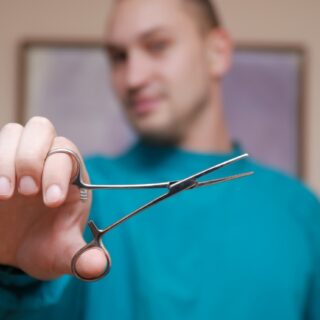 medical professional holding a medical tool