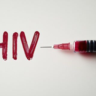 HIV written in red with syringe