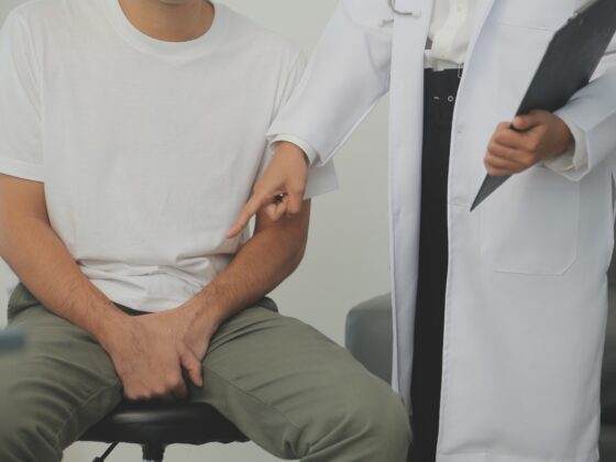 Man presses hands to his groin and suffering from pain