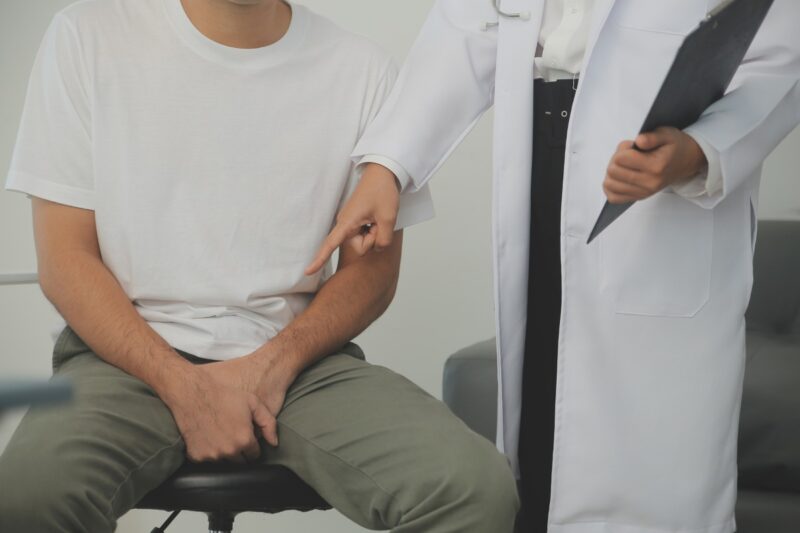 Man presses hands to his groin and suffering from pain